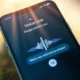 Google Gemini Live on iPhone lock screen displaying real-time voice chat with AI assistant.