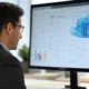 A professional working on a computer displaying digital marketing tools with AI, featuring Meta's branding and dynamic ad testing analytics in a modern office setting.