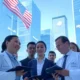 Group of professionals from healthcare, finance, and tech sectors discussing AI innovation in a modern U.S. cityscape, with American flag and Big Tech logos like Google and Amazon in the background.