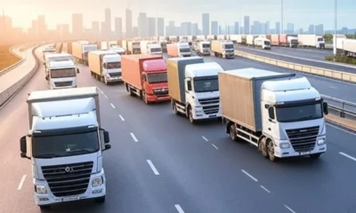 The scene highlights reduced traffic, clear roads, and timely deliveries, with overlays of real-time data showing fuel savings and advanced technology like machine learning and telematics integration.
