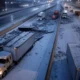 Delivery trucks stranded on a snow-covered highway in Chicago during a severe snowstorm, highlighting logistical challenges and delayed deliveries.